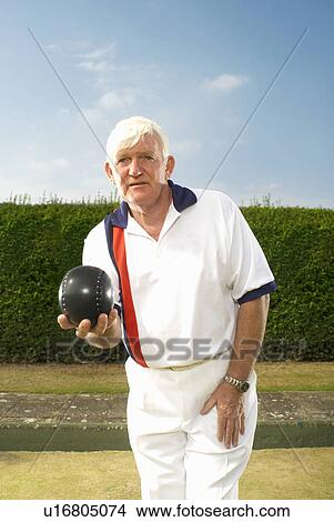 Picture - male bowler focussed. Fotosearch