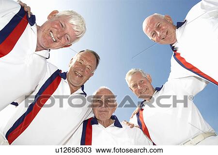 Stock Image - male bowlers leaning over camera. Fotosearch