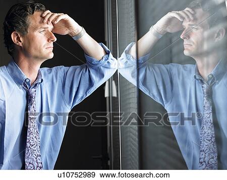 Man against window, thinking View Large Photo Image Stock Photo - Man against window, thinking. Fotosearch
