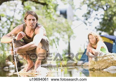 Man and woman at a river View Large Photo Image Stock Image - Man and woman at a river. Fotosearch
