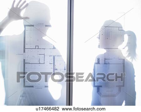 Man and woman behind blue prints View Large Photo Image Stock Image - Man and woman behind blue prints. Fotosearch