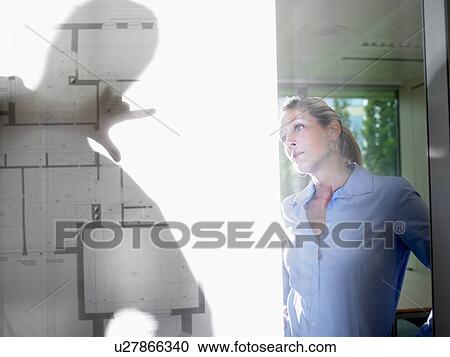 Man and woman behind blue prints View Large Photo Image Stock Image - Man and woman behind blue prints. Fotosearch