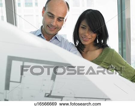 Man and woman looking at blue prints View Large Photo Image Stock Photo - Man and woman looking at blue prints. Fotosearch
