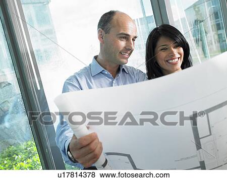Man and woman looking at blue prints View Large Photo Image Stock Photo - Man and woman looking at blue prints. Fotosearch