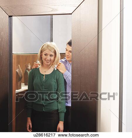man and woman trying on necklace View Large Photo Image Stock Photo - man and woman trying on necklace. Fotosearch