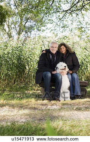 Stock Image - man and woman with dog. Fotosearch