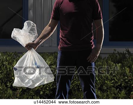 man carrying bag of water bottles View Large Photo Image Picture - man carrying bag of water bottles. Fotosearch