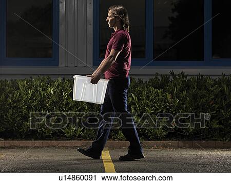 man carrying box at night View Large Photo Image Stock Image - man carrying box at night. Fotosearch