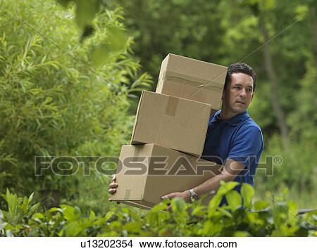 man carrying boxes View Large Photo Image Picture - man carrying boxes. Fotosearch