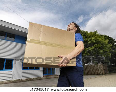 man carrying heavy box View Large Photo Image Stock Photo - man carrying heavy box. Fotosearch