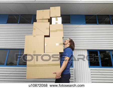 man carrying stack of boxes View Large Photo Image Stock Photo - man carrying stack of boxes. Fotosearch