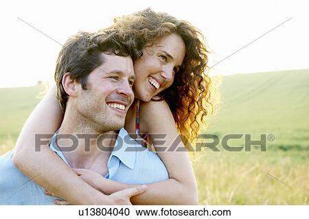 Man carrying woman in a wheat field View Large Photo Image Stock Image - Man carrying woman in a wheat field. Fotosearch