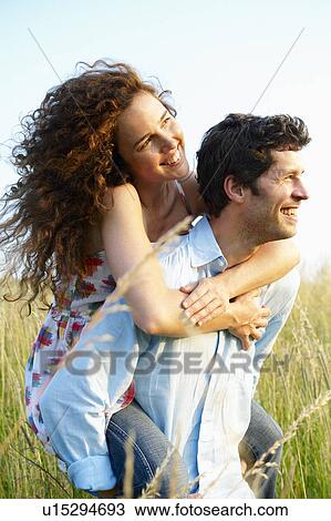 Man carrying woman in a wheat field View Large Photo Image Stock Image - Man carrying woman in a wheat field. Fotosearch