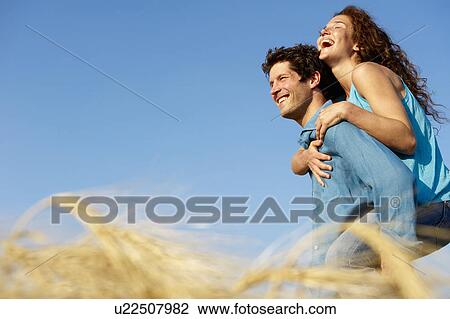 Man carrying woman in a wheat field View Large Photo Image Stock Image - Man carrying woman in a wheat field. Fotosearch