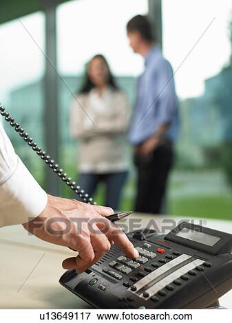 Stock Photo - Man dialing a number. Fotosearch