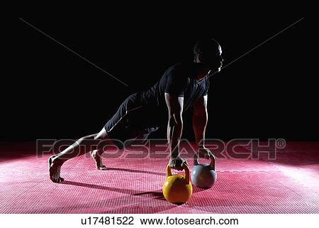 man doing press up with kettle bell View Large Photo Image Stock Image - man doing press up with kettle bell. Fotosearch