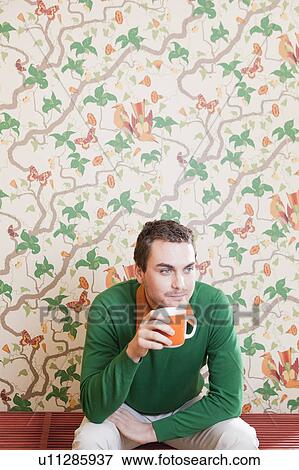Stock Photo - man drinking from cup. Fotosearch