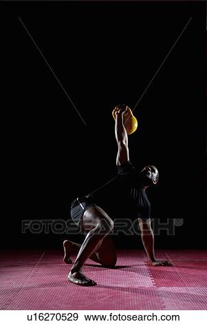 man getting up with kettle bell View Large Photo Image Stock Photo - man getting up with kettle bell. Fotosearch