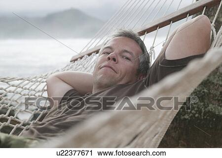 Stock Image - man in hammock. Fotosearch