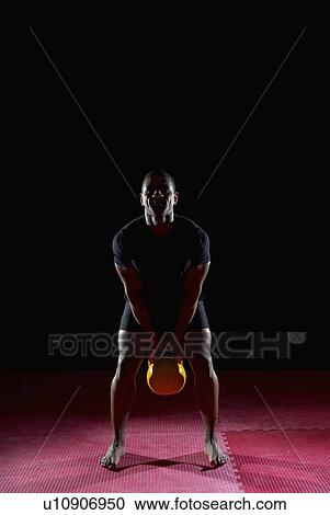 man lifting kettle bell, front on View Large Photo Image Stock Image - man lifting kettle bell, front on. Fotosearch