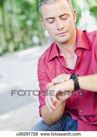 man looking at his watch View Large Photo Image Stock Photo - man looking at his watch. Fotosearch