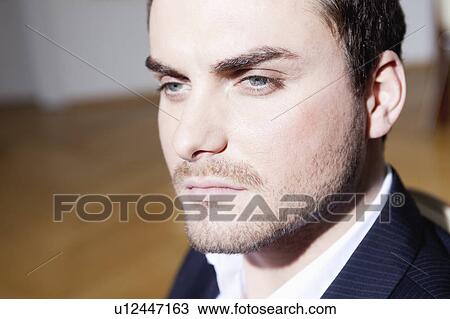 Stock Image - man looking serious. Fotosearch