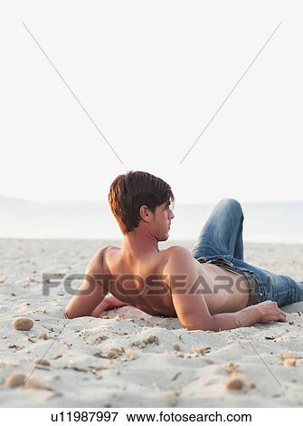 man lying on the beach View Large Photo Image Stock Photo - man lying on the beach. Fotosearch