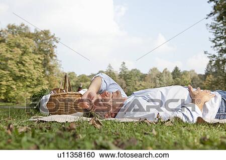 Stock Image - Man lying relaxed on a blanket. Fotosearch