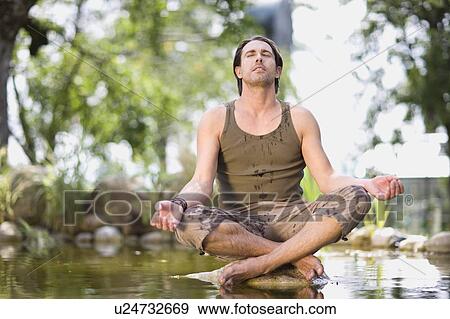 Stock Photo - Man meditating. Fotosearch