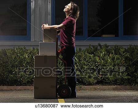 man moving boxes at night View Large Photo Image Stock Photo - man moving boxes at night. Fotosearch