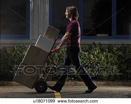 man moving boxes at night View Large Photo Image Stock Photo - man moving boxes at night. Fotosearch