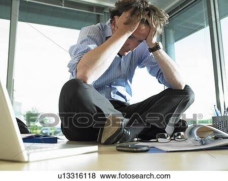 Man on his desk, thinking View Large Photo Image Stock Photo - Man on his desk, thinking. Fotosearch