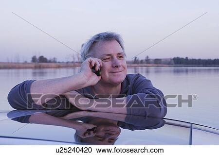 Stock Image - Man on mobile phone. Fotosearch