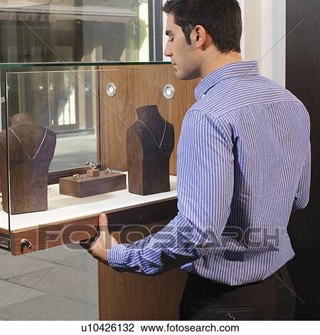 man opening/closing jewelry display View Large Photo Image Stock Image - man opening/closing jewelry display. Fotosearch