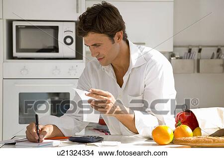 Picture - Man paying bills. Fotosearch
