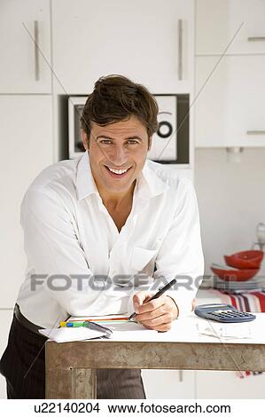 Picture - Man paying bills. Fotosearch