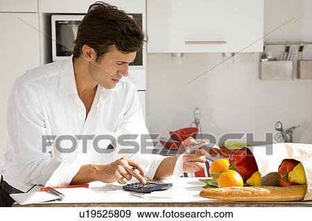 Stock Photo - Man paying bills. Fotosearch