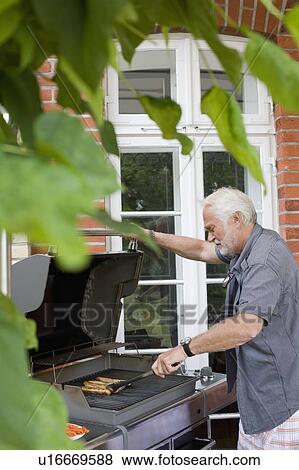 man preparing food for kids View Large Photo Image Stock Photo - man preparing food for kids. Fotosearch