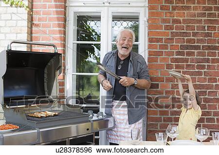 man preparing food for kids View Large Photo Image Stock Photograph - man preparing food for kids. Fotosearch