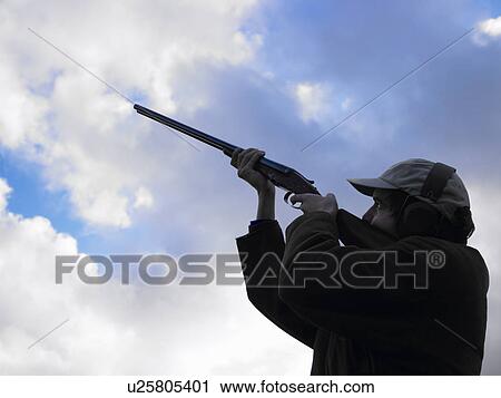 man shooting in the air View Large Photo Image Stock Image - man shooting in the air. Fotosearch