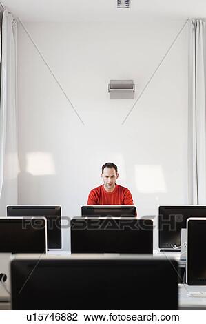 man sitting at terminal in lecture hall View Large Photo Image Stock Image - man sitting at terminal in lecture hall. Fotosearch