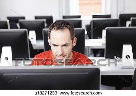 man sitting at terminal in lecture hall View Large Photo Image Stock Image - man sitting at terminal in lecture hall. Fotosearch