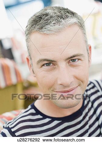 man sitting in a city cafe smiling View Large Photo Image Stock Image - man sitting in a city cafe smiling. Fotosearch