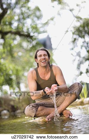 Man sitting in a river View Large Photo Image Stock Image - Man sitting in a river. Fotosearch