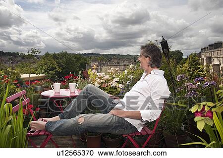 man sitting on balcony View Large Photo Image Stock Image - man sitting on balcony. Fotosearch