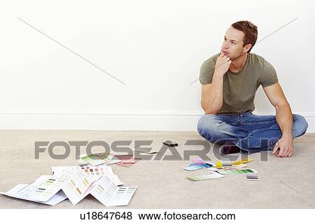 Man sitting on floor with colour samples View Large Photo Image Stock Photo - Man sitting on floor with colour samples. Fotosearch