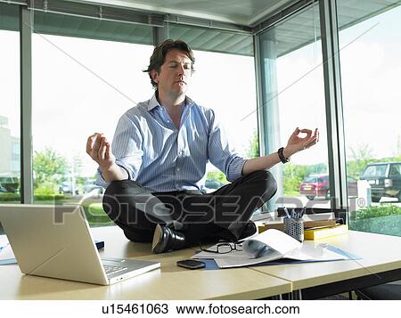 Man sitting on his desk, relaxing View Large Photo Image Stock Image - Man sitting on his desk, relaxing. Fotosearch