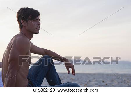man sitting on the beach View Large Photo Image Stock Photo - man sitting on the beach. Fotosearch