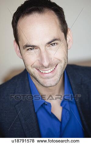 Stock Photo - man smiling at viewer. Fotosearch