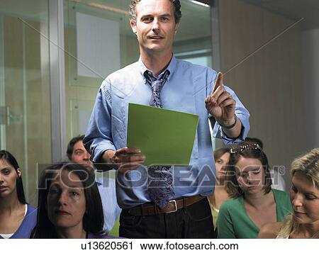 Stock Image - Man standing, asking a question. Fotosearch